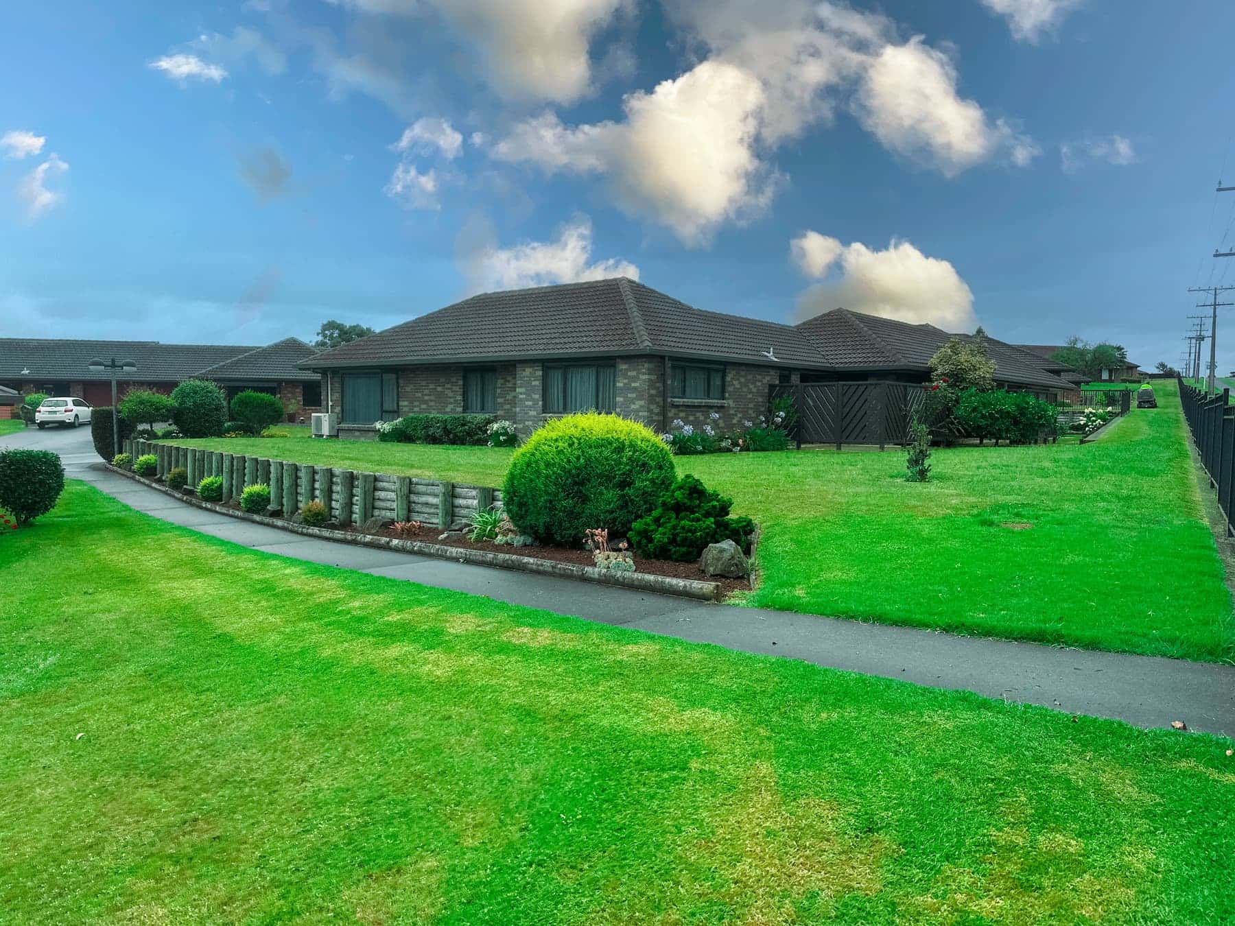 Wide village lawn and gardens