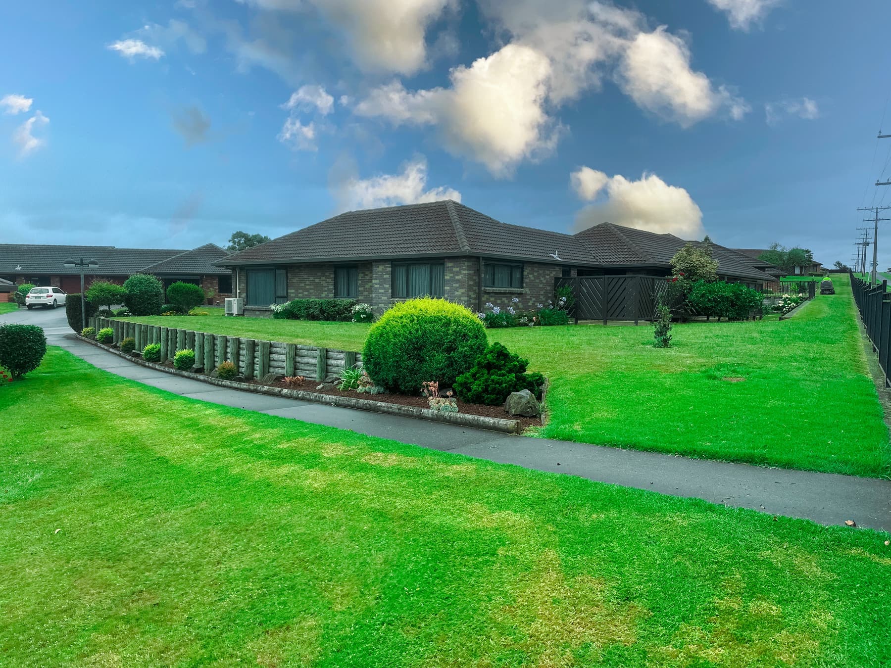 Wide village lawn and gardens
