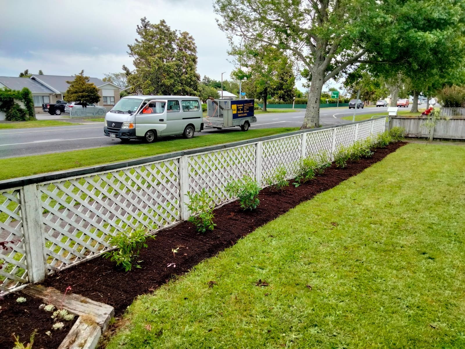 New bed along white picket fence