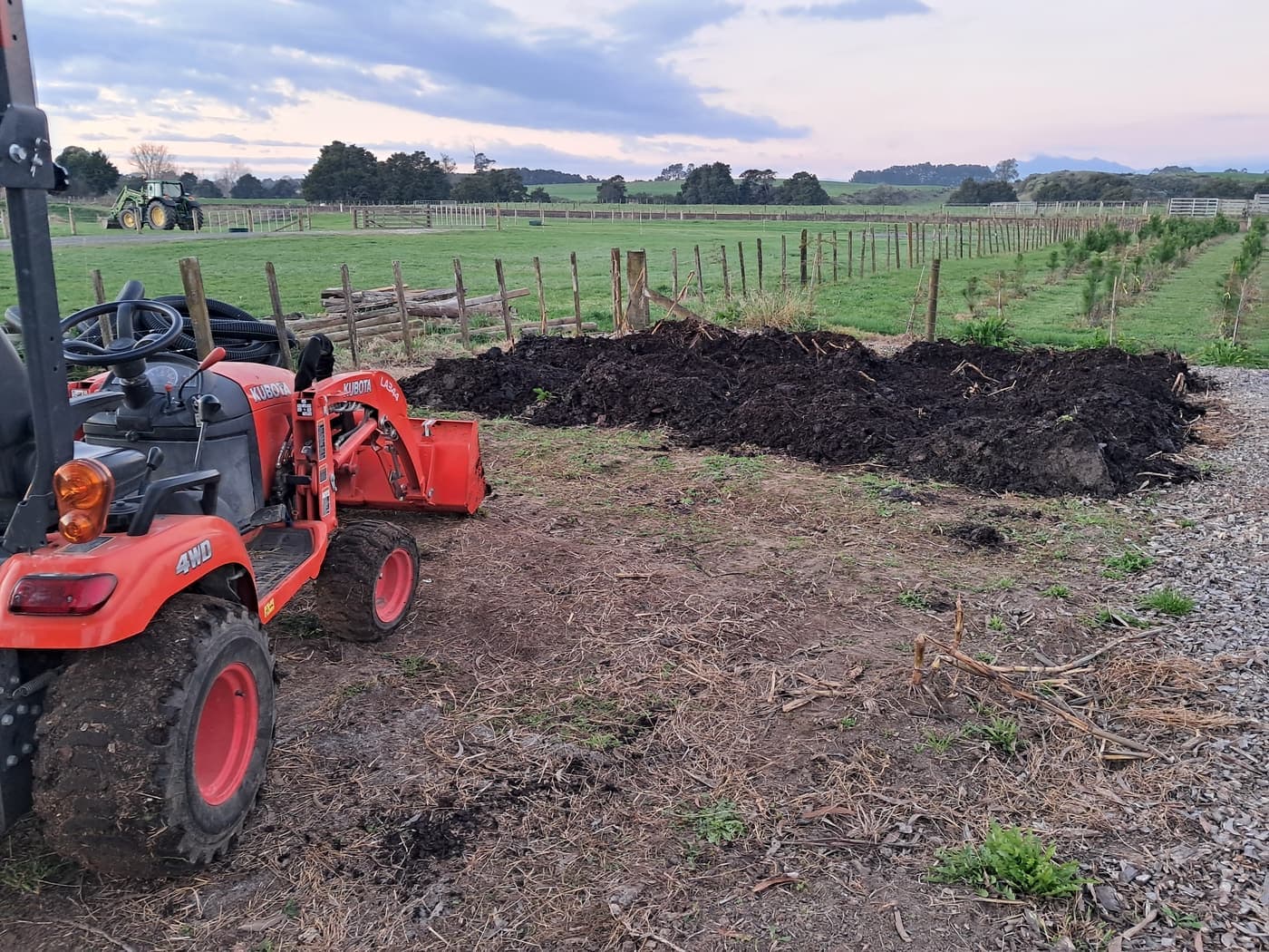 Tractor with mulch piles on farm
